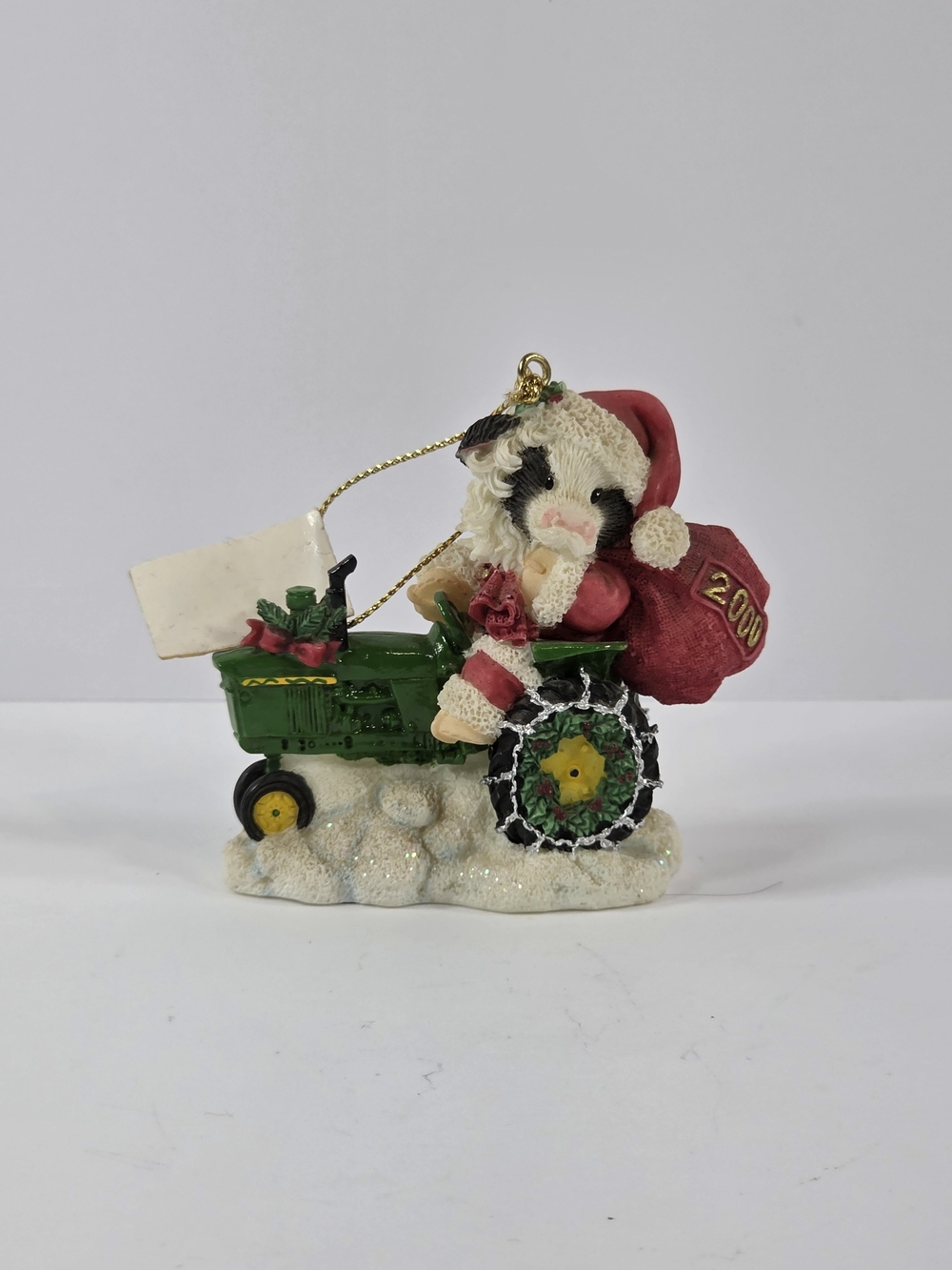 Enesco Festive Cow on Green Tractor Ornament with Red Santa Hat